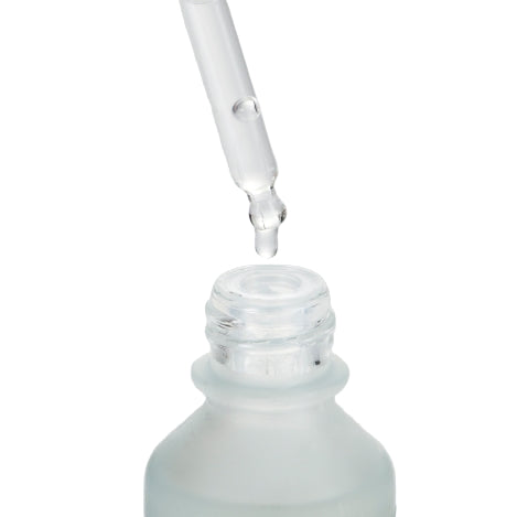 Glass dropper bottle with clear liquid on a white background